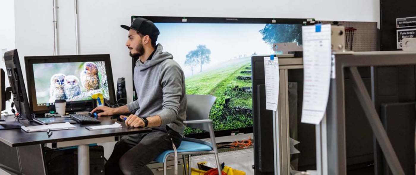 man with multiple computer monitors